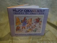 Front cover of the book showing title 'Qikaaluktut: Images of Inuit Life' and an Inuit drawing