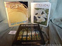 Photo of three large hardcover coffee table books on Art Nouveau style with distinctive covers as described.