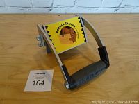 Photo of the Gorilla Gripper heavy duty panel carrier showing the metal frame, rubber grip handle, and the attached yellow label with logo.