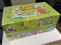Closed colorful early learning program box with cartoon characters and alphabet blocks design
