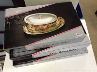 Stacked boxed Marinex 3-quart bakers showing product packaging for oval and oblong shapes.