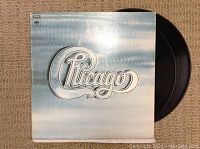 Photo of Chicago LP vinyl record with cover showing band logo.