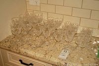 Full set of various Stuart Crystal stemware types grouped on countertop