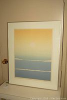 Full view of framed print with visible crack on glass and white mat around print.