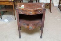 Front view of wood side table with drawer and open shelf, showing leather top with damage.