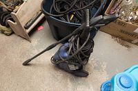 Front view of blue Simoniz CL 11 pressure washer with power cord and spray wand coiled and resting on the unit.