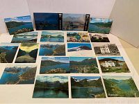 Photo of multiple vintage postcards laid out showing Balestrand Norway fjord views and some black and white images of buildings