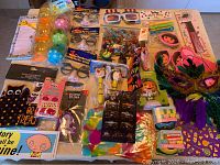 Overview photo showing assortment of kids holiday party favor toys and masks on table.