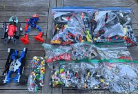 Photo showing multiple ziplock bags with assorted plastic building parts and assembled figures.