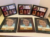 Six new sealed picture frames arranged on a white surface, three collage multi-photo frames with black borders and three single 8in x 10in frames with different finishes.