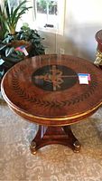 Top view showing inlaid center medallion and laurel wreath border