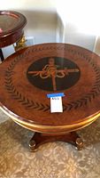 Full view of round table showing inlaid top and pedestal base
