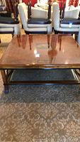 Front view showing overall design, inset walnut veneer top and curved legs