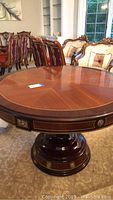 Round tabletop surface showing walnut veneer pattern and glossy finish