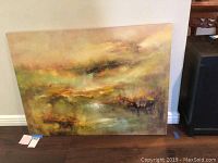 Full front view of the unframed abstract oil painting leaning against wall