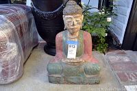 Front view of multicolored painted Buddha statue seated in meditation with label showing approximate size.