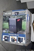 Boxed Mail Boss Package Master locking security mailbox showing the front picture of the product and usage details.