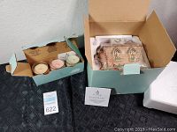 Box with three scented candles in glass jars and the Forest Friends tealight house box.