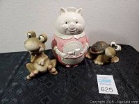 Front view of frog, pig, and turtle ceramic cookie jars with seller's lot card number 625