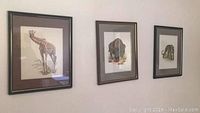 Three framed animal prints (giraffe, bison, elephant) hung on wall.