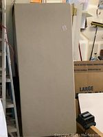 Photo of folded white plastic tabletop of Lifetime brand fold up table.