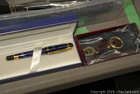 Waterman fountain pen and Aigner key chain in their original boxes, placed side by side on a surface.