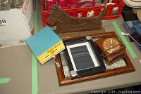 Overview of clock, Scottish terrier sculpture, carrying tray with boxed tester device on table