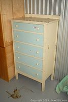 Full view of highboy chest showing cream and blue paint and overall wear