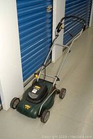 Yardworks electric compact lawnmower front and side view showing condition and rust spots.