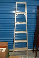 Front view of the aluminum step ladder showing all 5 steps and support braces.
