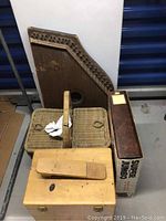 Photo showing vintage autoharp, woven picnic basket, wooden Ronson shoe care box, and boxed super jumbo photo album.