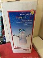 Box showing the fiber optic snowman indoor use only with color changing lights and approved adapter included