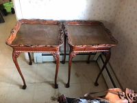Pair of carved wooden side tables shown together illustrating size, shape and general condition