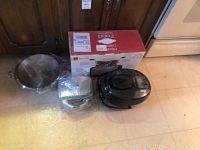 Rondo Ready Grill, black with cord; Aroma Rice Cooker black digital model; Cooks Essentials Brownie Maker in box; Wolfgang Puck casserole pan wrapped in plastic