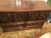 Front view of the Lane chest showing carved wood front and two metal-handled bottom drawers.