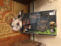 Photo showing boxed Chair Gym with exercise mat and packaging on the floor.