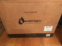 Closed cardboard box with Waterlogic Hybrid logo and branding, model WL-3262, size and weight info visible.