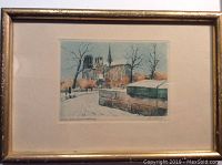Framed block print featuring Notre Dame Cathedral in snow, showing whole frame and image.