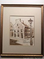 Full framed original sketch showing building and street lamp, neutral matting and simple wooden frame.