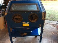 Front view showing viewing window, glove ports and lower shelf