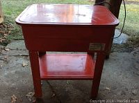 Red metal 20 gallon parts washer with basin and stand, visible signs of light use.
