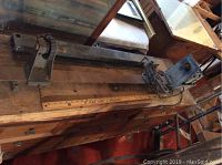 Wood lathe mounted on a wooden base with an electric motor installed, ruler placed for scale.