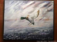 Full view of the oil painting showing the mallard duck flying over water and cloudy sky background.