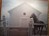 Framed print showing horse in fence and church facade