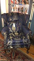 Front view of chair with matching pillow showing upholstery pattern and overall condition
