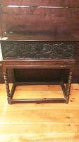 Front view of carved foliage motif on front panel and drawer