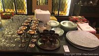 Full table view showing all types of drinking vessels, plates, bowls, linens, and flatware box arranged