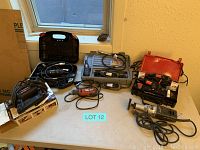 Wide view of all rotary tools, cases, and accessories on table under window