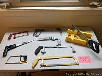 Photo showing various saws and miter box arranged on a table