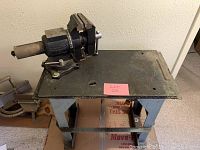 Overall view of the workbench vice mounted on the metal table stand showing condition and dimensions